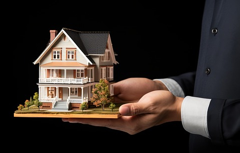 Man holding a small model home